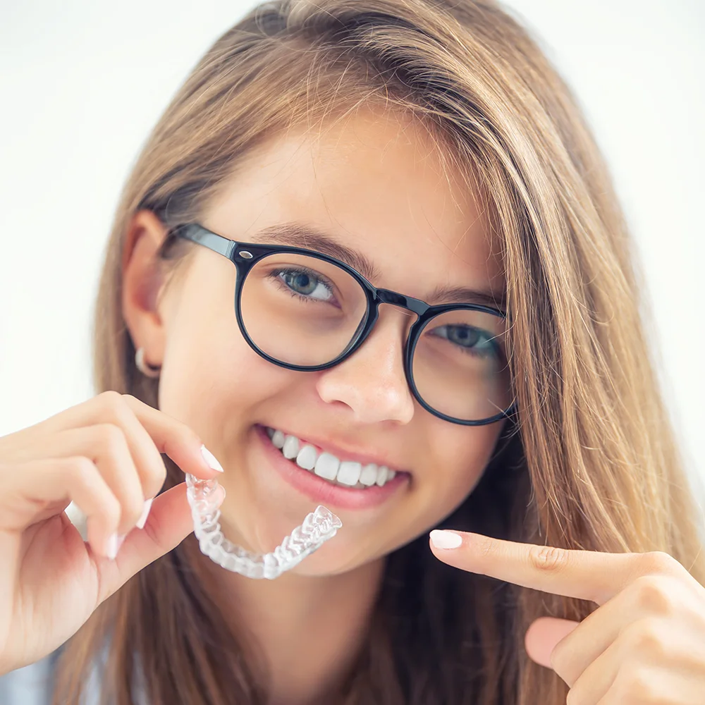 Young woman holding Clear Aligner