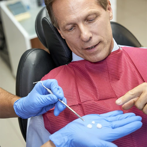A woman getting sitting on a dental chair and getting prepared.
