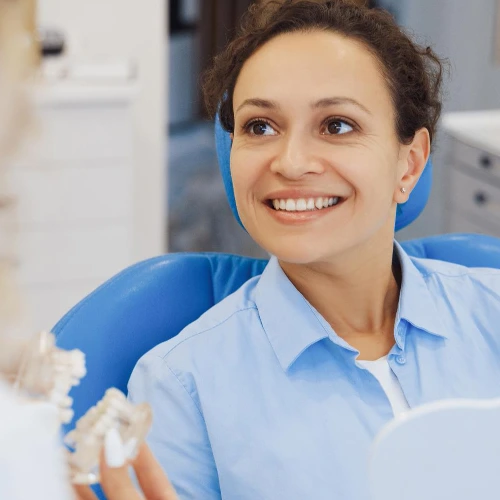 A woman getting sitting on a dental chair and getting prepared